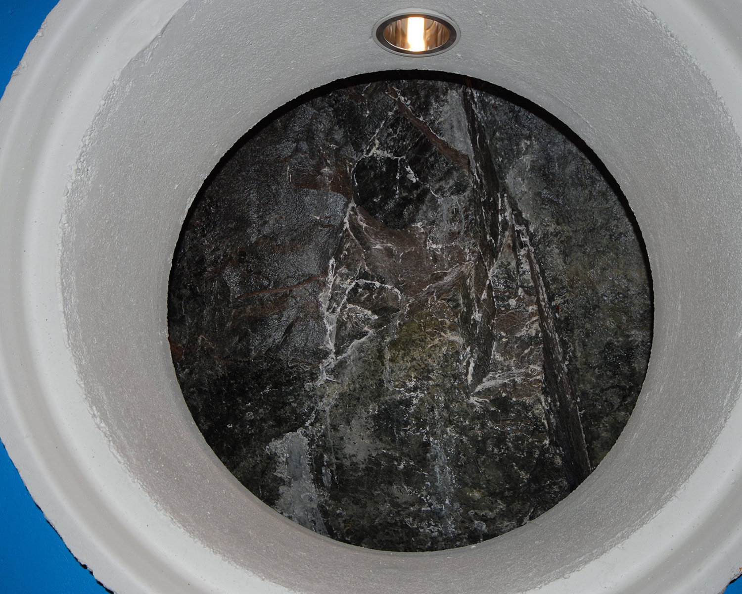 The décor and lighting elements contrast with bare rock face inside machine hall.