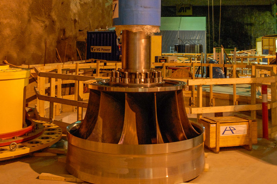 The shaft of the one Francis turbine towers inside the cavern