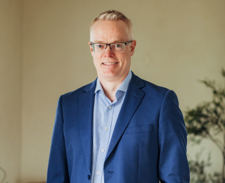 Man with glasses smiling